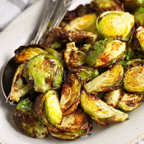 AIR FRYER BRUSSEL SPROUTS on a plate with fancy spoon