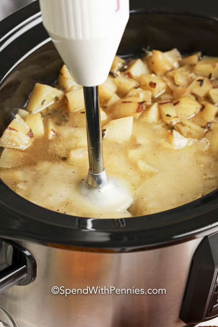 Crockpot Potato Soup in a crockpot with an immersion blender