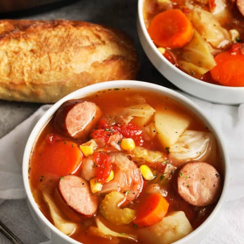 Two bowls of crockpot potato and sausage soup.