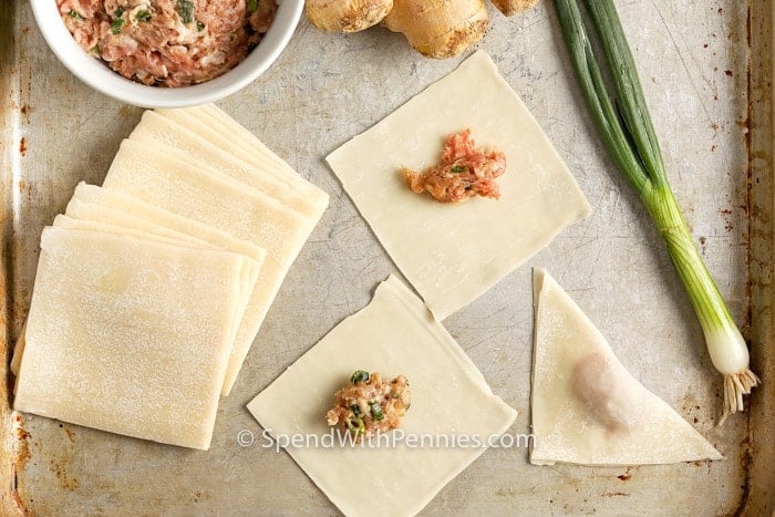folding Fried Wontons on a baking sheet