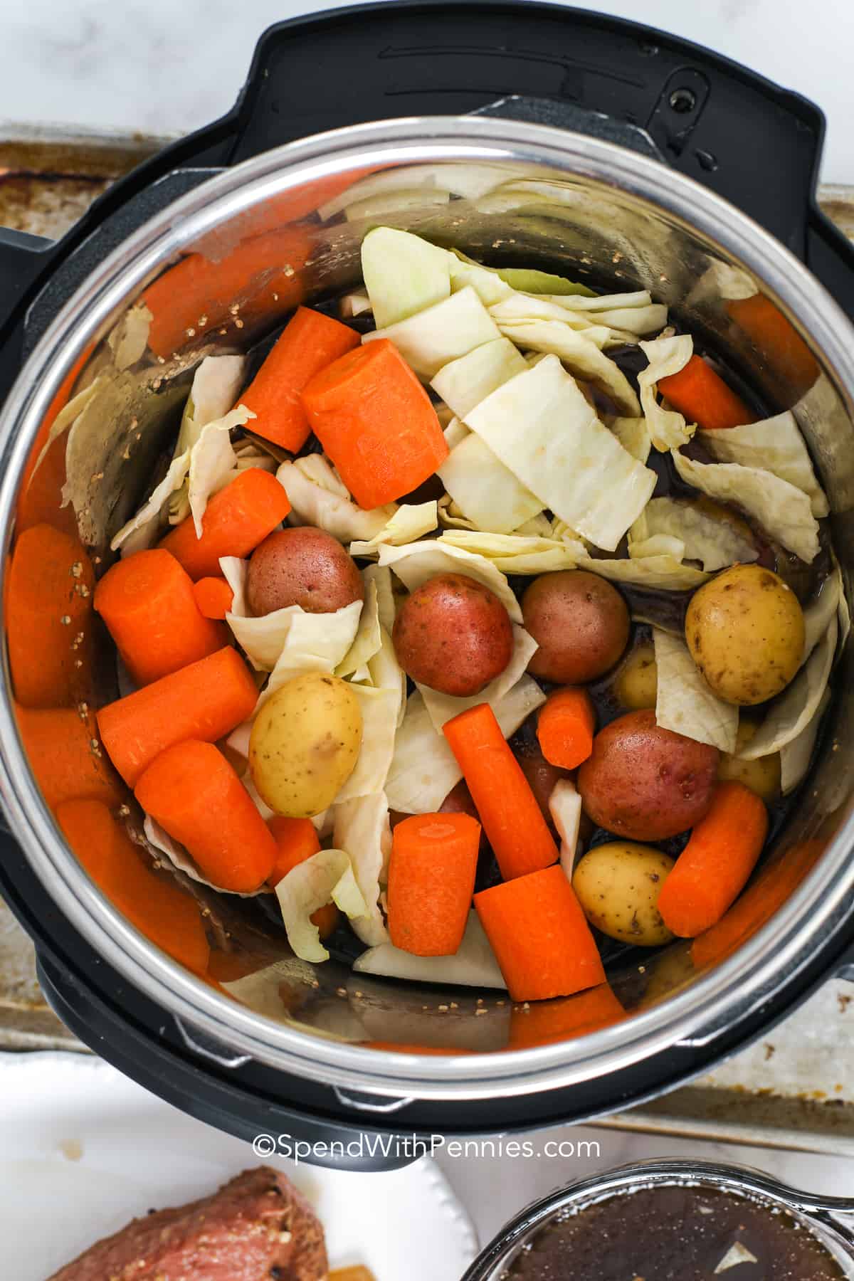 Corned beef brisket cooked in the Instant Pot is so easy to make! With potatoes, cabbage, and carrots, it is a complete meal in one pot. Make it tonight for a quick weeknight meal! #instantpotcornedbeef #cornedbeefbrisket #instantpot #spendwithpennies vegetables in an instant pot