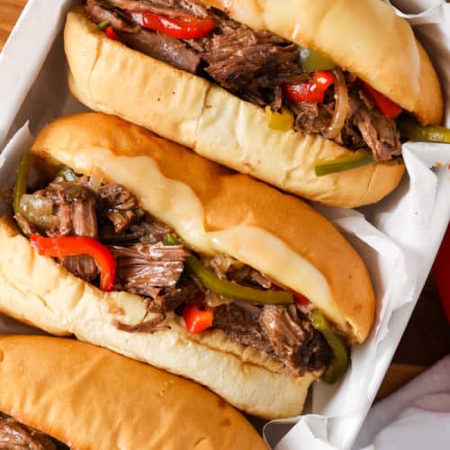 Three Slow Cooker Cheesesteaks in a tray