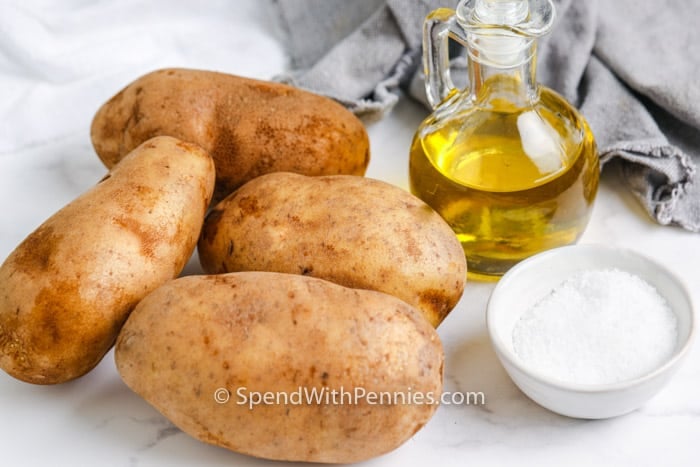 ingredients to make Air Fryer Baked Potatoes on a marble table top