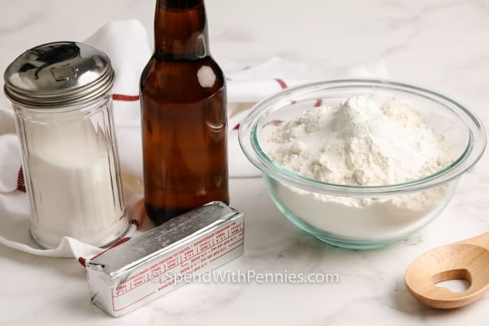 Homemade beer bread is a no yeast, no rise bread that is almost fool-proof to make. With a handful of simple ingredients and delicious additions like cheese, sundried tomatoes, or honey, this is one of the best bread recipes! Serve it with a bowl of soup for a cozy lunch or dinner! #beerbread #easybreadrecipe #homemadebeerbread #spendwithpennies Beer Bread ingredients