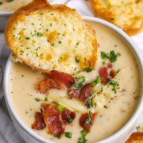 beer cheese soup with a cheese toast and bacon on top