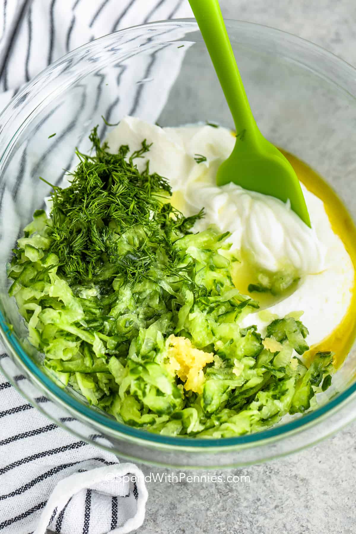 adding ingredients to a bowl for Tzatziki Sauce