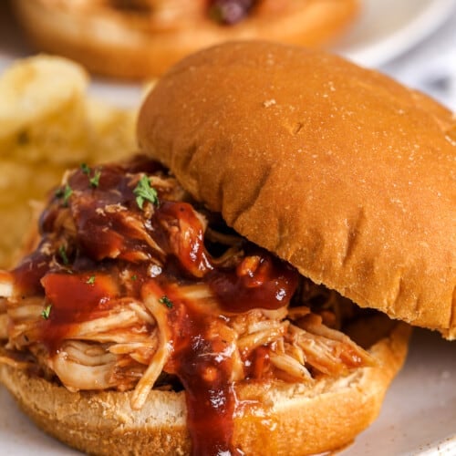 crockpot bbq chicken on a bun with potato chips