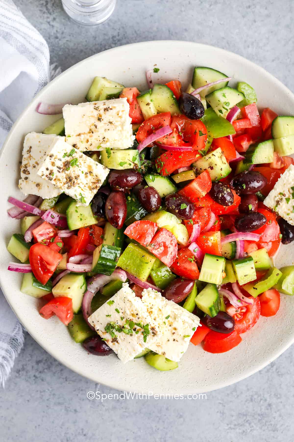 Greek salad in a bowl on a grey counter