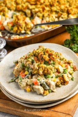 Chicken Stuffing Casserole on a plate with casserole dish full in the back.