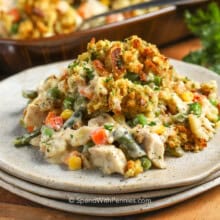 Chicken Stuffing Casserole on a plate with casserole dish full in the back.