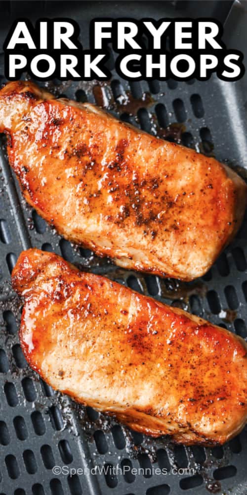 Two pork chops cooked in an air fryer with writing