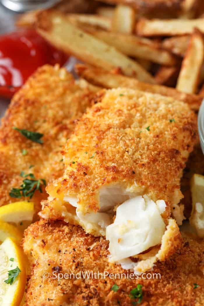 Air Fryer Fish and Chips on a plate with a bite taken out of the fish nugget