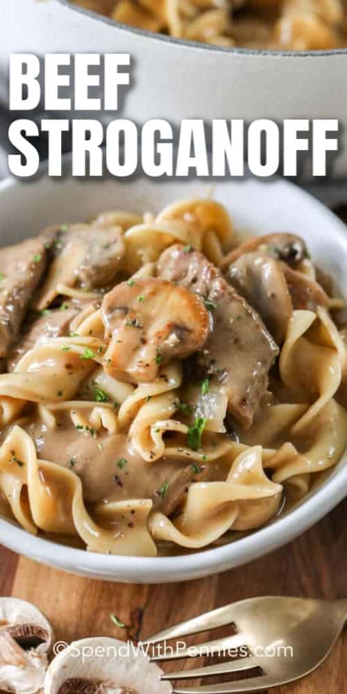Homemade beef stroganoff recipe is one of our favorite family dinners. It's full of tender juicy steak and earthy mushrooms in a rich, brown gravy sour cream sauce! #spendwithpennies #beef #stroganoff #beefstroganoff #easybeefstroganoff #beefmushroomstroganoff #beefstroganoffrecipe close up of Easy Beef Stroganoff with a title