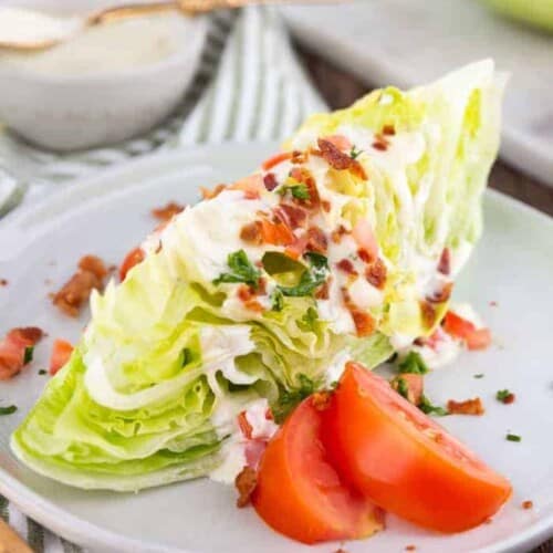 wedge salad on a plate with tomatoes