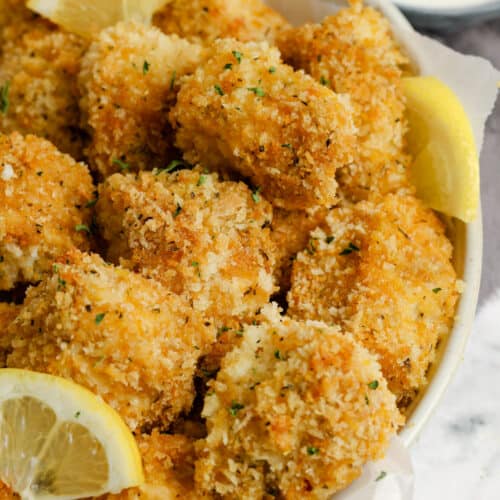 Fish bites in a white bowl with parchment paper