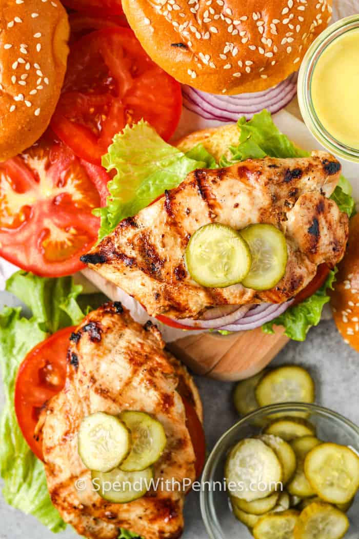 Grilled chicken sandwiches are the best in summer dining. What’s not to love about juicy and tender chicken that is infused with flavors of a perfect marinade. Then it is sandwiched between a soft bun, topped with honey mustard, lettuce and tomatoes. So delish! #grilledchickensandwichrecipe #easygrilledchickensandwich #spendwithpennies top view of open Grilled Chicken Sandwich
