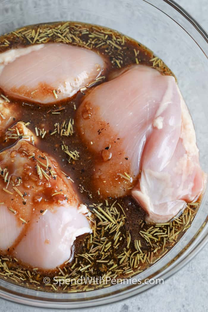 These Grilled Chicken Thighs are marinated with a balsamic-brown sugar marinade, then grilled until tender & juicy. Serve these with potatoes or rice and a side salad for a delicious Summer meal! #spendwithpennies #grilledchickenthighs #recipe #maindish #boneless #grilled chicken in marinade before mixing to make Grilled Chicken Thighs