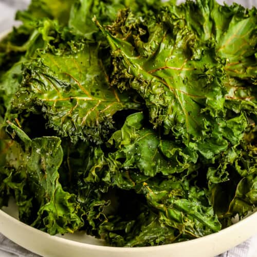 a bowl of cooked kale chips