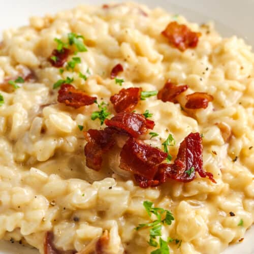 close up of Instant Pot Risotto on a white plate with bacon