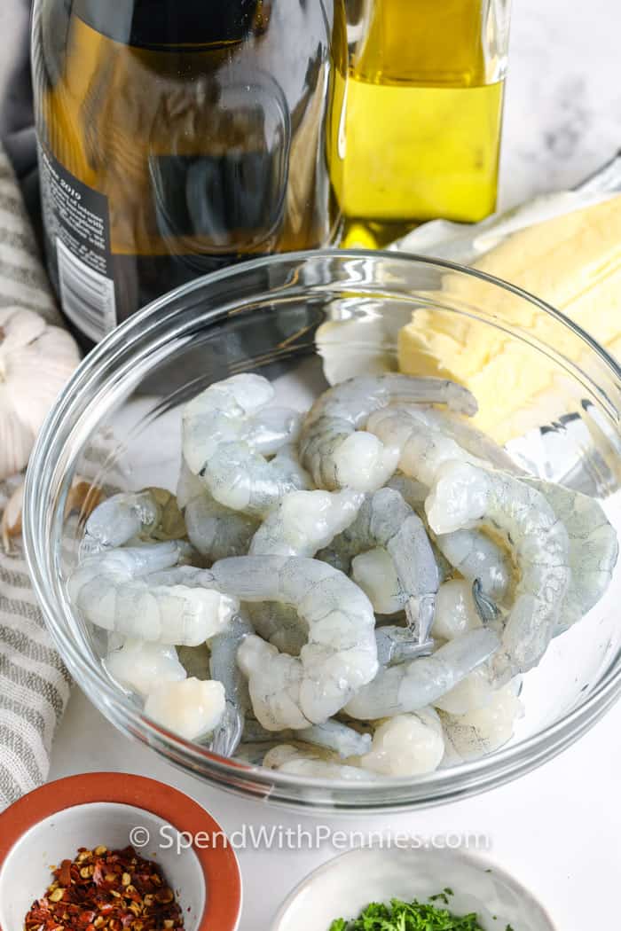 In just 20 minutes, you can have a mouthwatering Easy Shrimp Scampi Recipe on your table. The shrimp is cooked in a delicious garlicky white wine sauce, creating a flavorful combination. It's a super quick meal that's perfect for those busy weeknights when you need a tasty dish in a hurry. #shrimpscampi #recipe #pasta #spendwithpennies ingredients to make Shrimp Scampi
