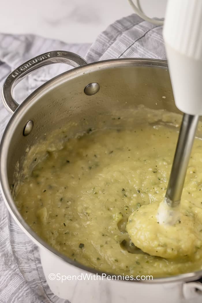 Zucchini Soup in a pot being blended with an immersion blender