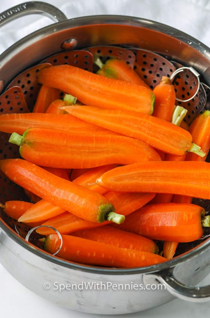 Fresh from the garden or market, steamed carrots are the perfect vegetable side dish. Try them as a salad topper, or eat them as a healthy snack! #spendwithpennies #steamedcarrots #recipe #sidedish Steamed Carrots in a strainer