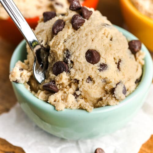 a small green bowl of edible cookie dough with chocolate chips