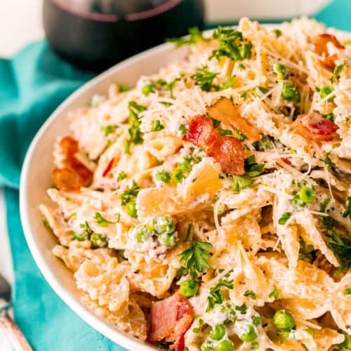 Farfalle with Bacon plated with a spoon beside