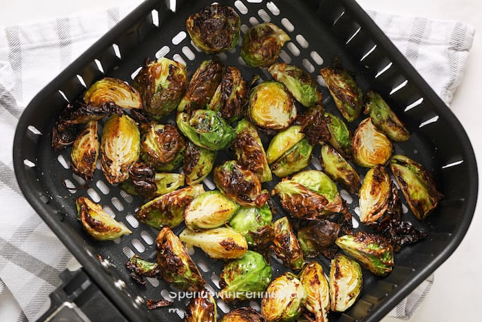 Cooked brussels sprouts in an air fryer basket