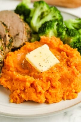 close up of cooked Boiled Sweet Potatoes with butter melting on top