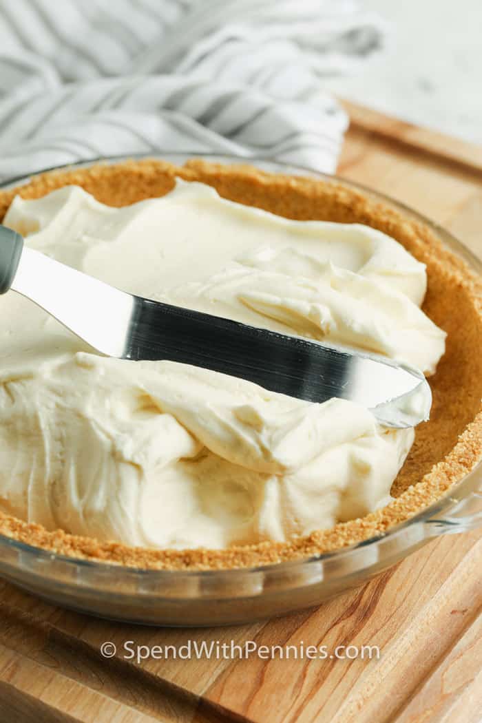 No Bake Cheesecake is such an easy dessert for a party or potluck! Make some homemade toppings and let guests choose their own. Strawberry, caramel, or even chocolate cheesecake is always a hit! #spendwithpennies put filling in pie shell to make No Bake Cheesecake