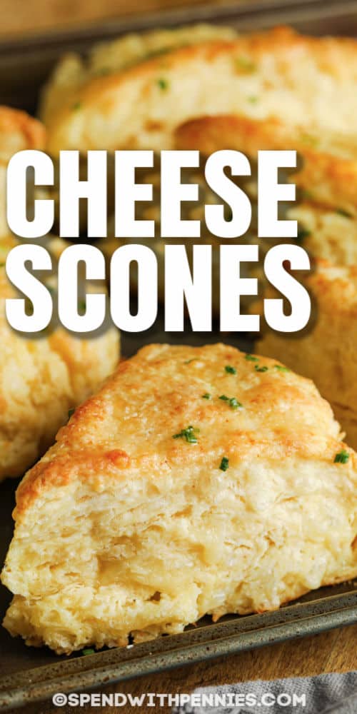Chive and garlic butter combine perfectly with the flavor of Cabot Cheddar Cheese to complement this easy recipe for cheese scones. Homemade savory scones are the perfect snack or breakfast treat for any occasion! #spendwithpennies #cheesescones #pastry #sidedish #recipe #cream #bacon #cabotcheddar #ham #easy close up of Cheese Scones with writing