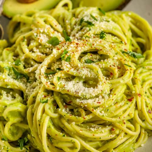 Avocado Pasta on a plate with avocado on the side