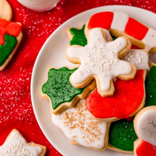 Christmas Cut Out Cookies on a plate with a glass of milk
