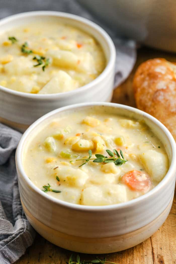 bowls of Quick Potato Corn Chowder with a loaf of bread beside it
