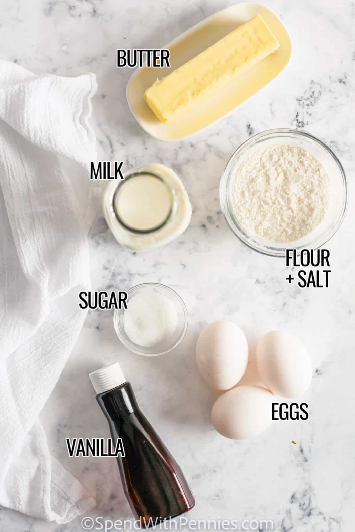 Dutch Babies are the perfect meal to serve for breakfast or brunch! The crowd will love these deliciously light & fluffy pancakes that can be topped with fresh fruit, syrup, and whipped cream! Or try making Dutch Babies for lunch with savory toppings like cheese & bacon. They are as easy to make as they are delicious! #dutchbaby #dutchbabypancakes #dutchbabyrecipe #spendwithpennies Ingredients for Dutch Baby on a marble counter