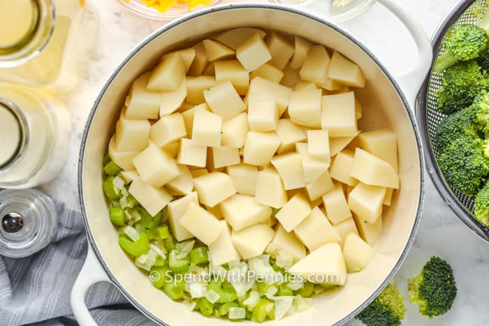 top view of ingredients in the pot to make Potato Broccoli Soup before adding broccoli and blending