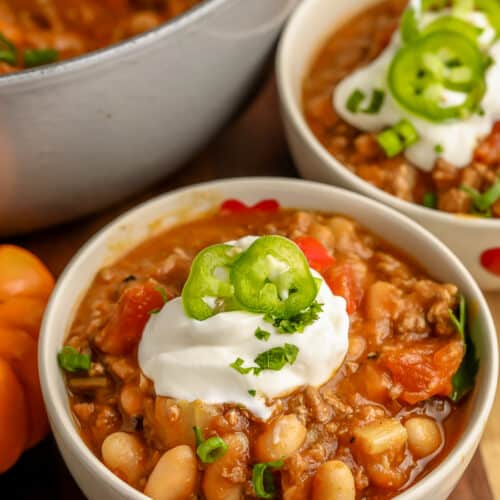 Pumpkin Chili in white bowls with sour cream