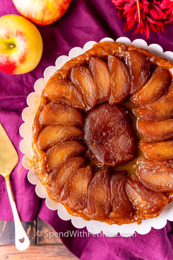 top view of finished Tarte Tatin with apples beside it