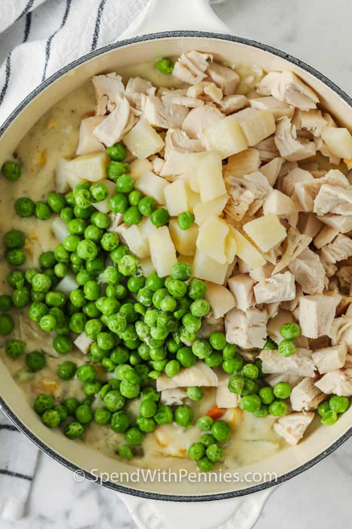 Homemade chicken pot pie is one of the best ways to enjoy an old fashioned comfort meal. Packed with hearty vegetables, tender chicken, and a creamy gravy, it’s all wrapped in a flaky, golden crust. Speed things up with rotisserie chicken or leftover meat, or take your time making it all homemade. Bake in a casserole for a crowd, or freeze one for a cozy dinner anytime. #spendwithpennies adding peas , potato and chicken to filling for Chicken Pot Pie