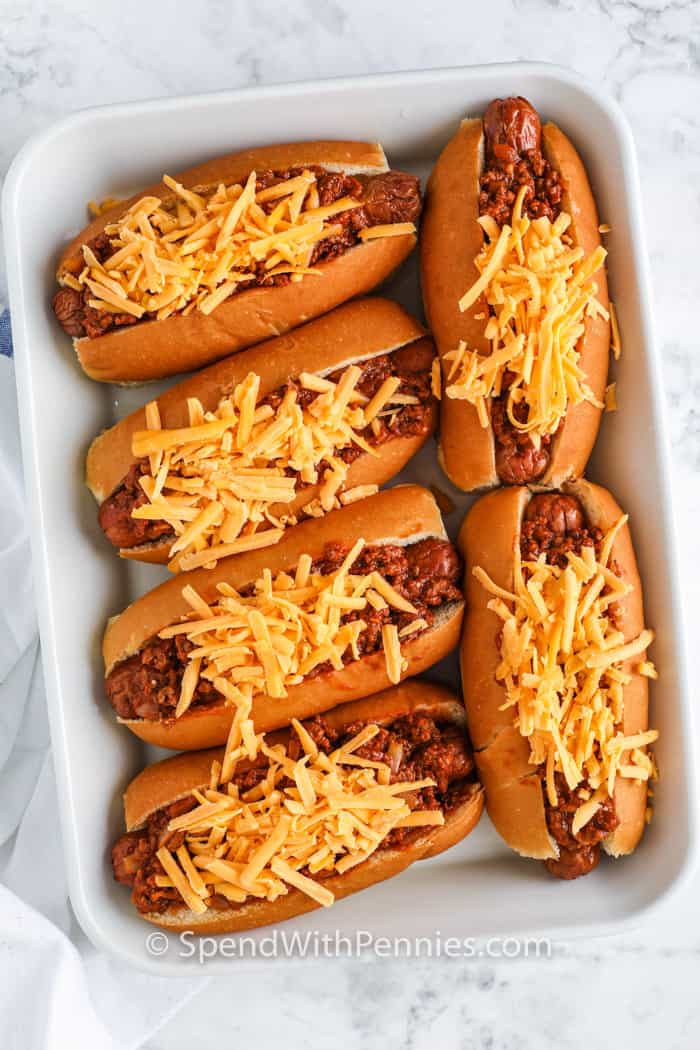 Chili cheese dogs are always a favorite when you need a hot recipe that feeds a crowd. These baked beauties are stuffed with juicy dogs, rich chili, and layers of cheddar. They're cozy, hearty, and loaded with flavor in every bite. For an easy twist, layer everything into a baking dish and make a chili cheese dog casserole. It’s the best way to turn leftovers into something totally crave-worthy. #spendwithpennies adding cheese to Chili Cheese Dogs