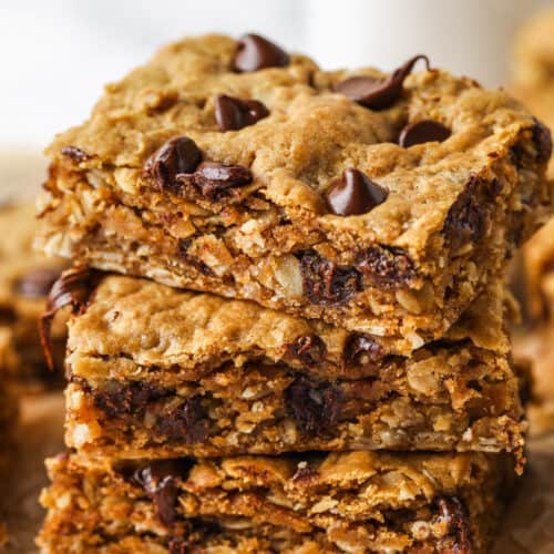 pile of Peanut Butter Oatmeal Bars with gooey chocolate chips