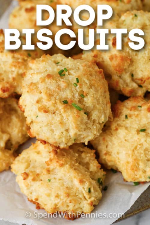 These super fluffy homemade drop biscuits are so easy to make and use just one bowl. Ready in 20 minutes, they are the best baking powder biscuits ever! #spendwithpennies #dropbiscuits #sidedish #recipe #easy #homemade #garlic #fluffy #parmesan #bisquick #best Garlic Drop Biscuits with writing