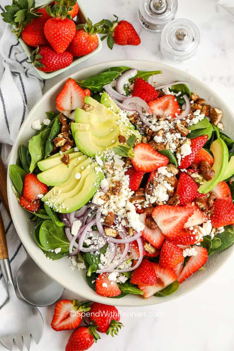 strawberry spinach salad with avocado in a bowl