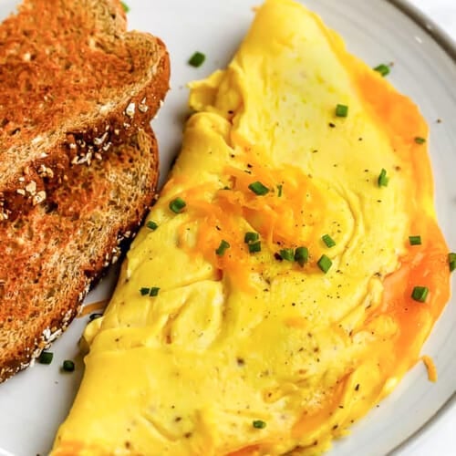 an omelette on a plate with toast