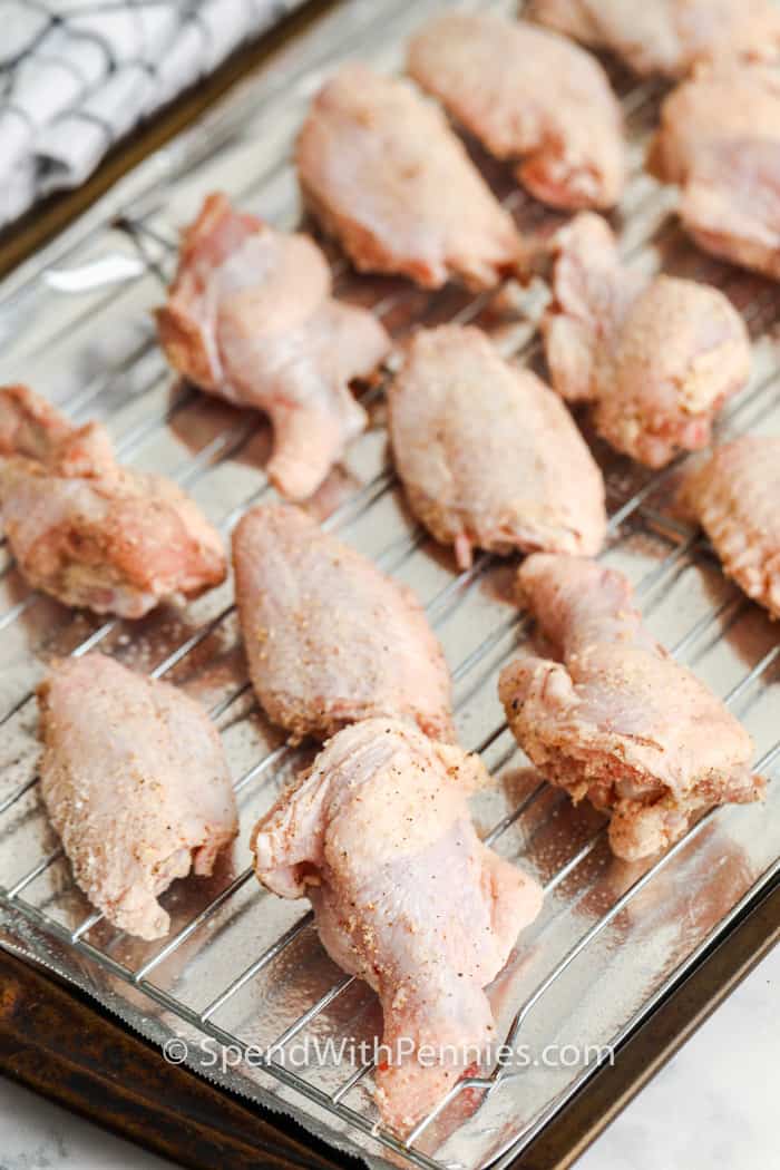 These oven baked chicken wings turn crisp with pantry staples and a few smart tricks. Drying the wings and baking on a rack lets heat circulate, and a short uncovered chill sets the coating. One simple ingredient helps the skin puff and crackle as they bake. Cook until golden, then broil briefly for color. They work with any sauce, and leftovers reheat best on a rack to bring the crunch back. #spendwithpennies chicken on a rack to make Actually Crispy Oven Baked Wings