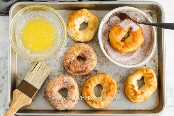 process of adding cinnamon and sugar to Air Fryer Donuts