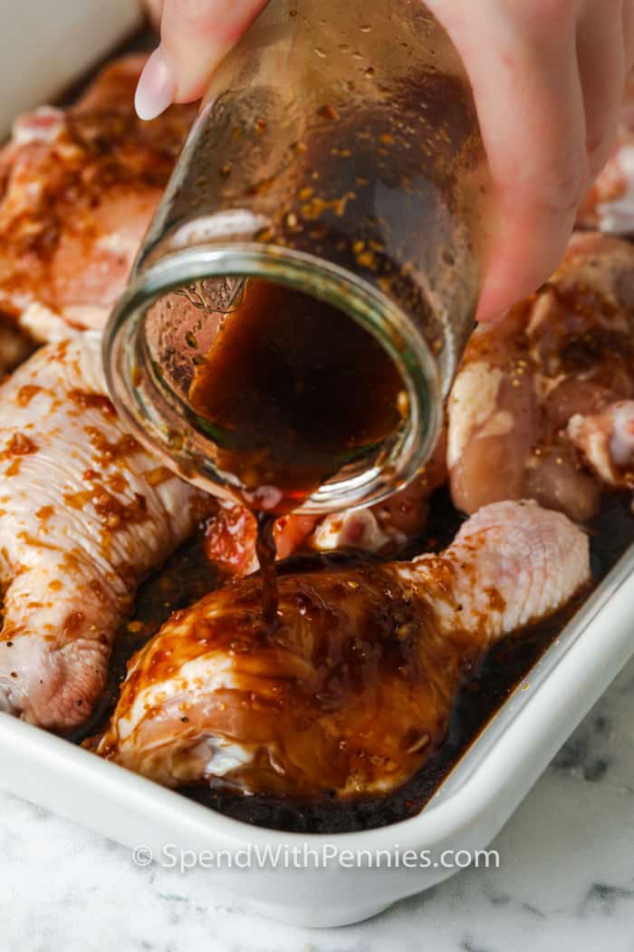 close up of sauce being poured over chicken to make Baked Teriyaki Chicken