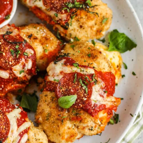 Pizza Stuffed Chicken on a plate with dip