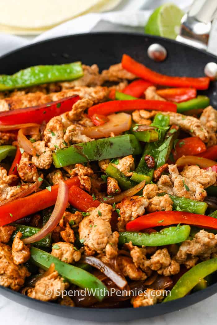 meat and vegetables cooking in the pan to make Pork Fajitas